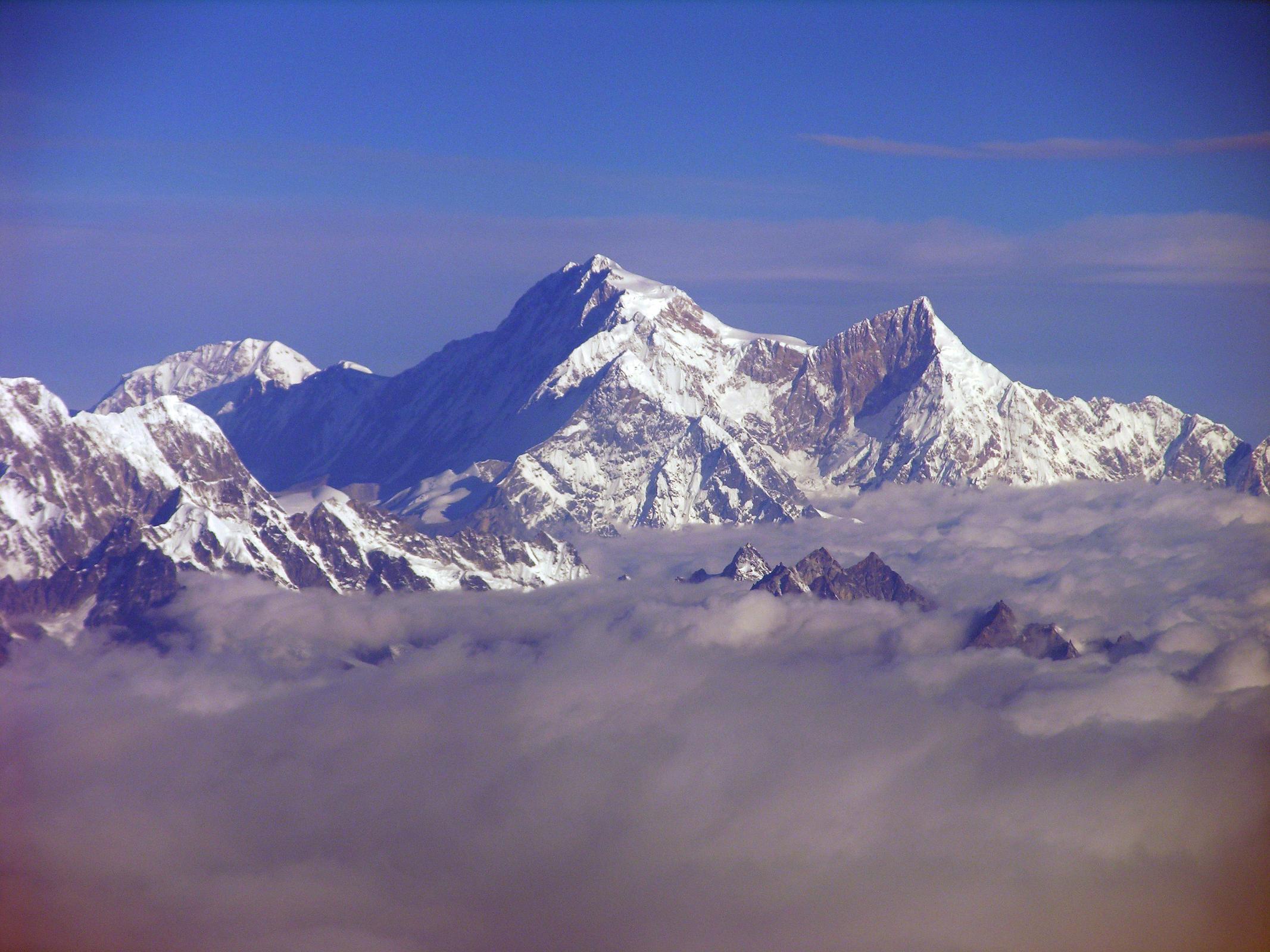 Kangchenjunga 01 04 Mountain Flight Shishapangma Long View Shishapangma, the 14th highest mountain in the world at 8012m, shines in the early morning sun from Kathmandus Mountain flight. The steep and treacherous southwest face is in shadow on the left. The north face is just visible in the sun on the right. On the far right the pointy rocky peak is Phola Gangchen (7716m), first climbed in 1981, and to its left is Shishapangmas East face.